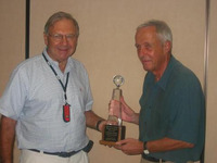 Yves Costel receives the first price in 2008 WCBC in Las Vegas from TD Al Levy. WBridge5 won the final against Jack with 172-157.