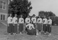 "Go Green Dragons!" E.K. Powe cheerleaders stand on what is now the lower playground. Group includes Barbara Wagstaff, Pat Ball, Lois Jane Riley, Faye Weaver, and Barbara Sutton Andrews (1949).