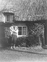Jane Leticia Blackburn (1873-1958) outside her cottage in early 1930s, holding her grandson, Tony Kent