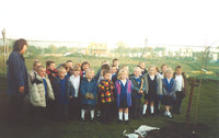 First School children help plant a tree at Mulberry Gardens, 2003. The tree will always be as old as the estate.