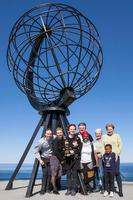 Gathered in front of the famous landmark at North Cape: Prizewinner Mari Maurstad (with The Children of the Earth statuette) flanked (left) by her son Aslak and Children of the Earth chairwoman Kristin Rivelsrud Juul Møller. To Maurstad’s right stand Nick Philips, Popi Buthelezi, Jannicke Rotwitt and Silvia Hellesvik, all with ties to Zulufadder. In front (right) smiles Lulu, who attends 4th grade at Gratton school, and who met the children of Magerøya island and experienced snow, reindeer and midnight sun. Photo: Christian N.B. Christensen.