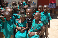 Prize winner Richard Kiwanuka with some of the many orphaned street children that he helps to a new life in Uganda's capital Kampala.