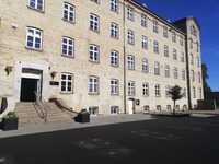 Den lille dør til højre for FÆNGSELS museet. 1. syd til højre, 2. dør på højre hånd. 😊