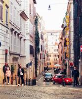 Une rue de Monti, avec pavés typiques et Fiat 500 rouge.